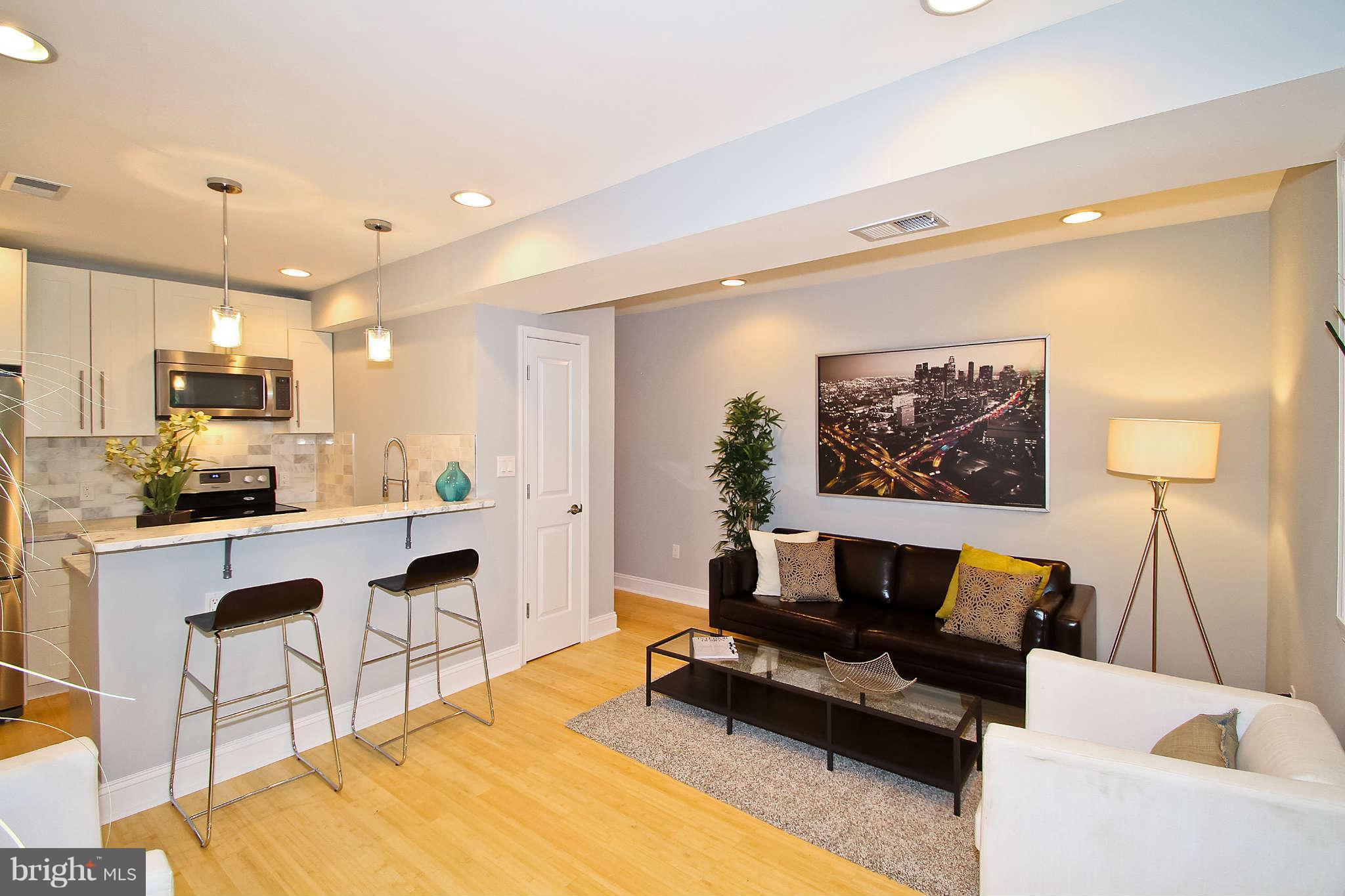 604 Columbia Road Northwest, Unit 1 Washington, DC 20001 - Photo 2 of 17 a living room with furniture and a flat screen tv