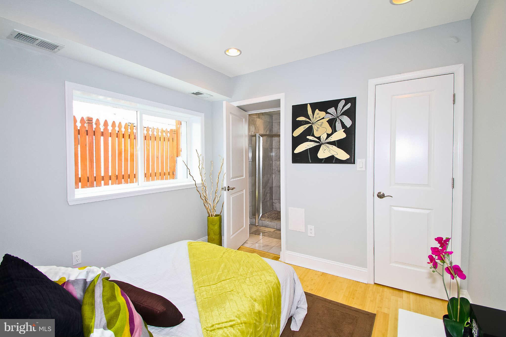 604 Columbia Road Northwest, Unit 1 Washington, DC 20001 - Photo 9 of 17 a bedroom with a bed and a painting on the wall