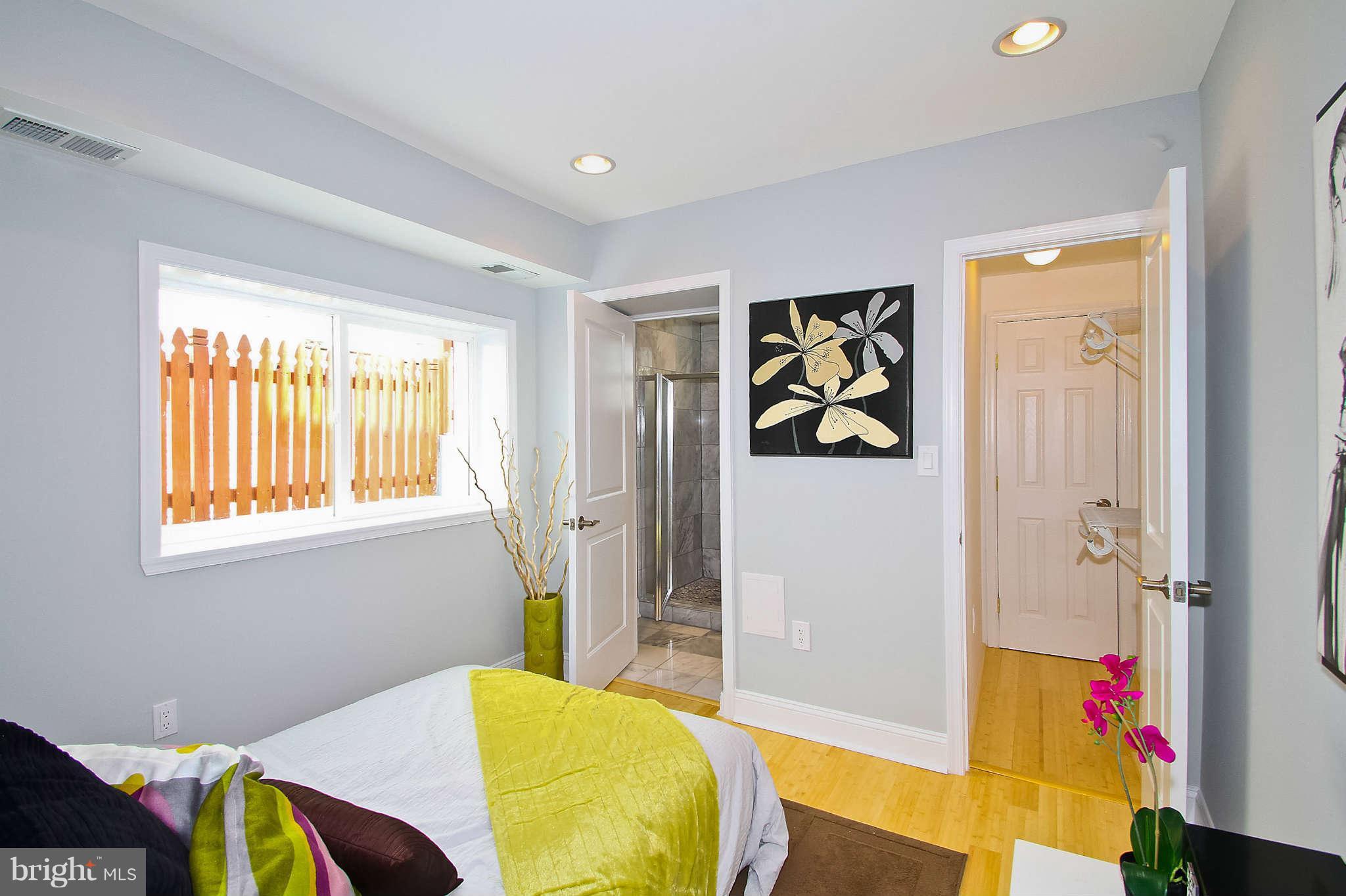 604 Columbia Road Northwest, Unit 1 Washington, DC 20001 - Photo 10 of 17 a bedroom with a bed and a painting on the wall