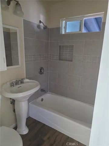 a white bath tub sitting next to a white sink