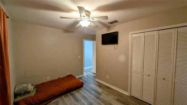 a view of a room with wooden floor and windows