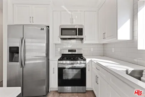 a kitchen with a stove and a microwave