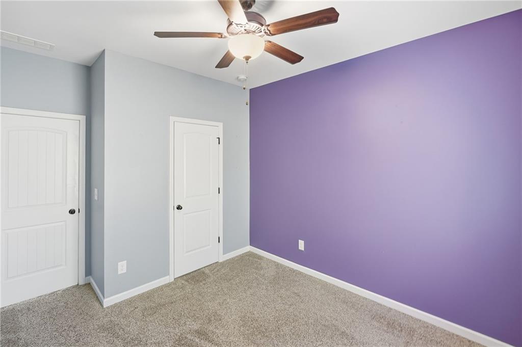 112 Spring Way Square Canton, GA 30114 - Photo 17 of 41 an empty room with a ceiling fan and a window