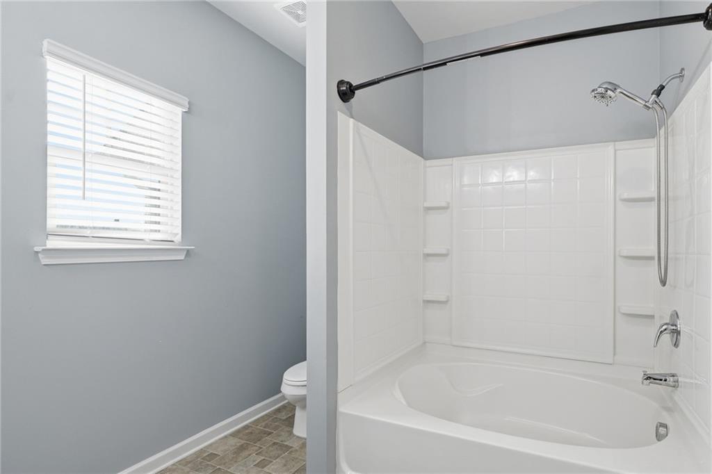112 Spring Way Square Canton, GA 30114 - Photo 20 of 41 a bathroom with a bathtub and a window
