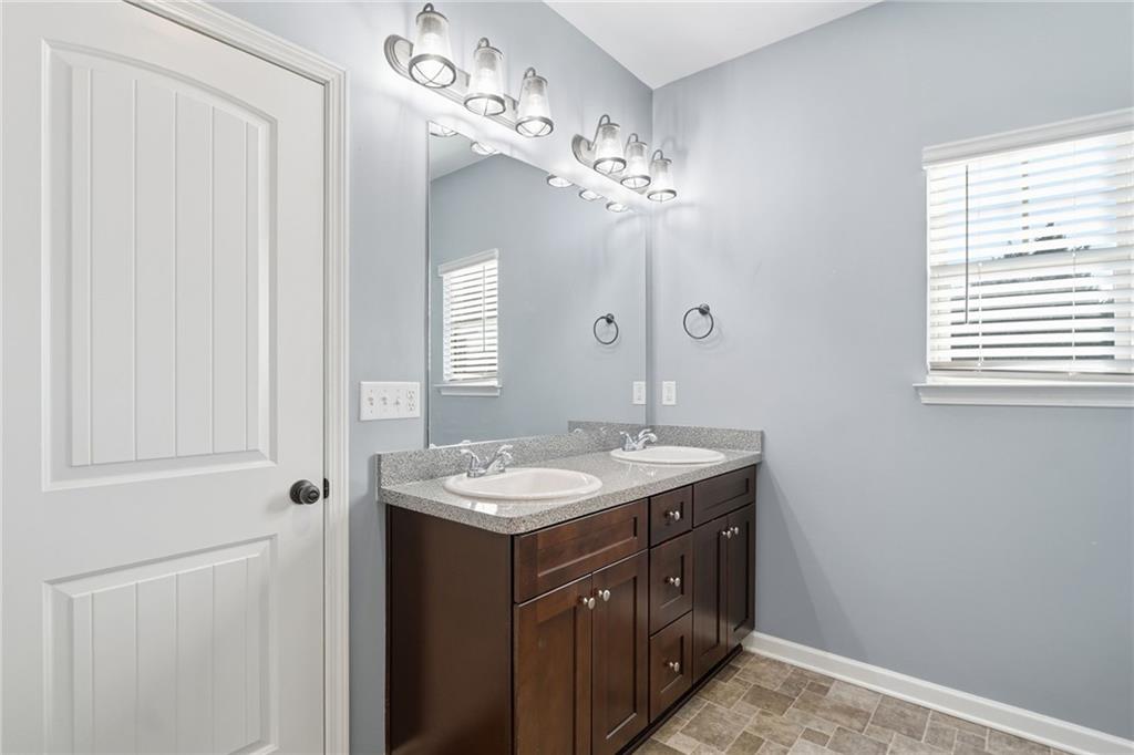 112 Spring Way Square Canton, GA 30114 - Photo 23 of 41 a spacious bathroom with a granite countertop sink a mirror and a vanity