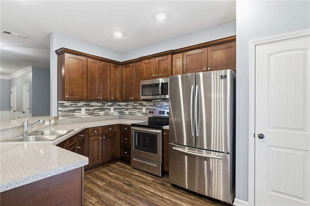 112 Spring Way Square Canton, GA 30114 - Photo 3 of 41 a kitchen with stainless steel appliances granite countertop a refrigerator and a sink