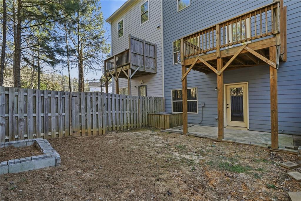 112 Spring Way Square Canton, GA 30114 - Photo 34 of 41 a view of a small house with wooden fence