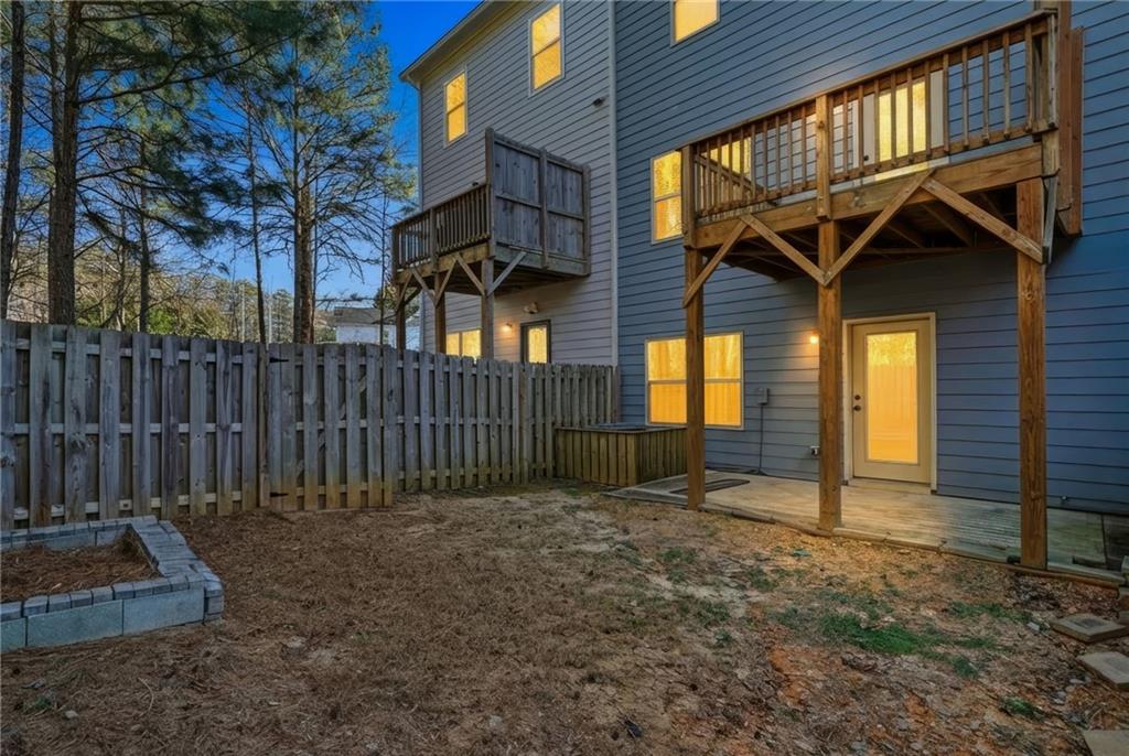 112 Spring Way Square Canton, GA 30114 - Photo 35 of 41 a view of a backyard with wooden fence and large trees