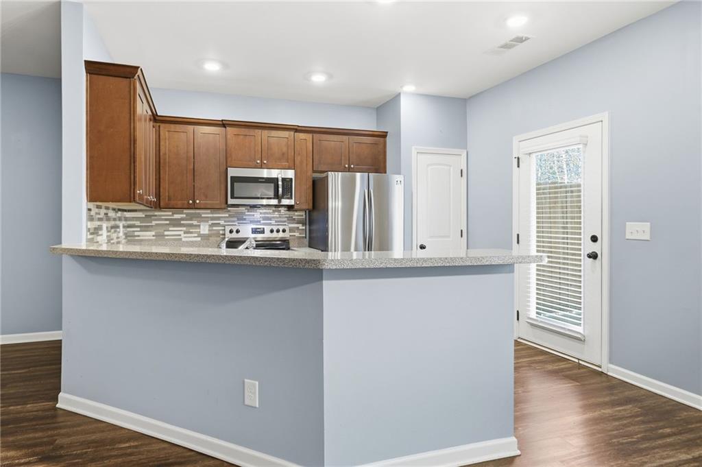 112 Spring Way Square Canton, GA 30114 - Photo 5 of 41 a kitchen with stainless steel appliances granite countertop a refrigerator and a stove top oven