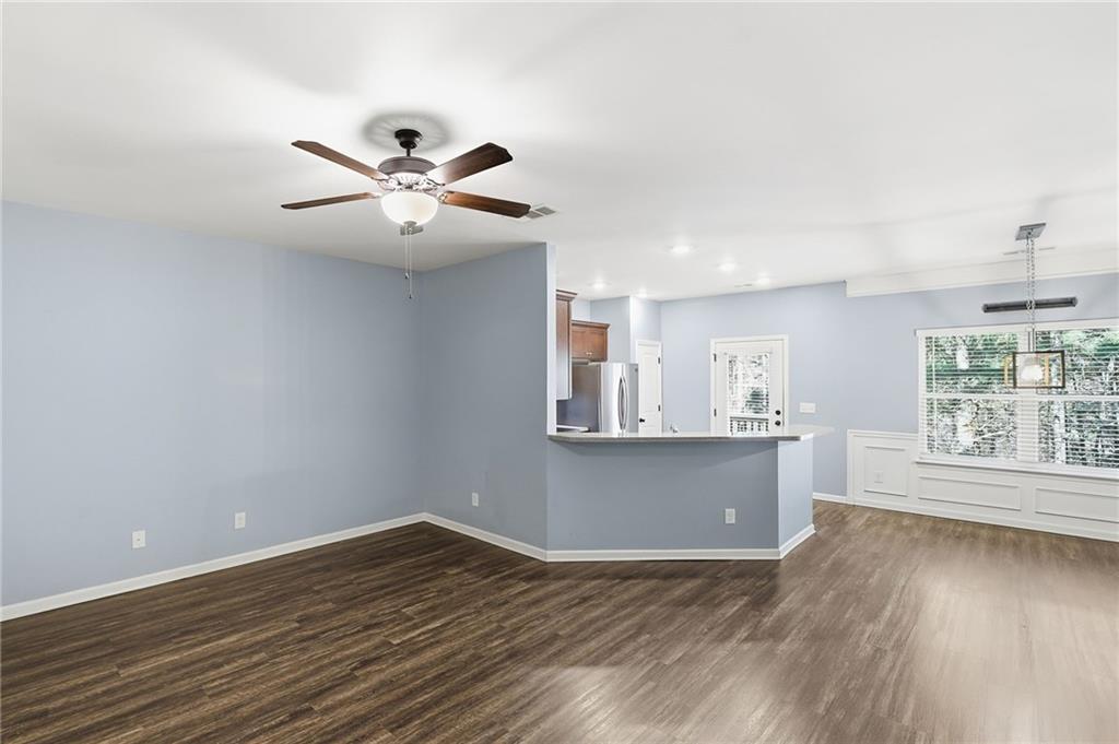 112 Spring Way Square Canton, GA 30114 - Photo 7 of 41 a view of an empty room with window and wooden floor