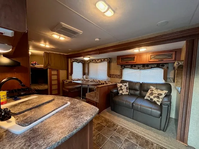 a kitchen with stainless steel appliances granite countertop a refrigerator and a stove top oven