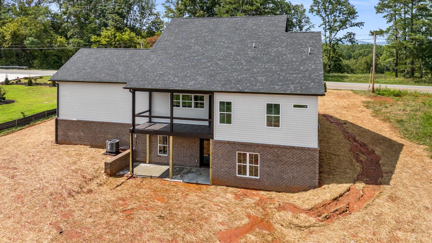6605 Forest Road Goode, VA 24556 - Photo 12 of 58 a backyard of a house with yard and trees in the background