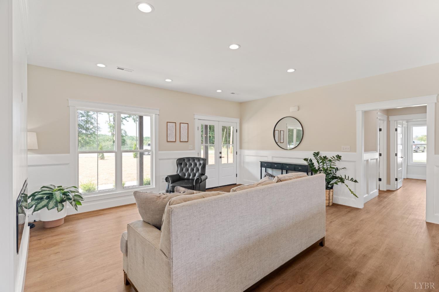6605 Forest Road Goode, VA 24556 - Photo 19 of 58 a living room with furniture a large window and wooden floor