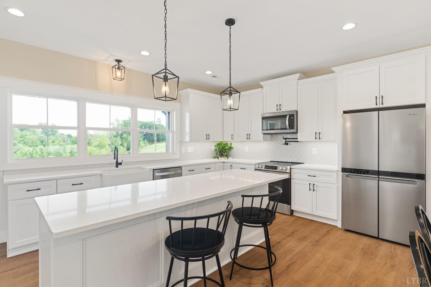 6605 Forest Road Goode, VA 24556 - Photo 23 of 58 a kitchen with kitchen island a large counter space and stainless steel appliances