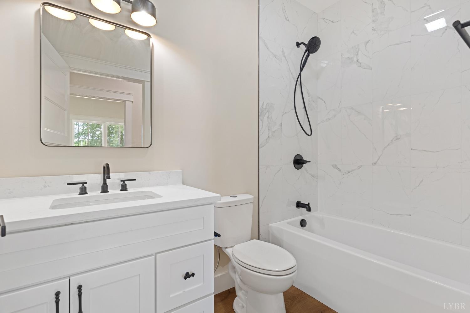 6605 Forest Road Goode, VA 24556 - Photo 30 of 58 a bathroom with a sink toilet and shower