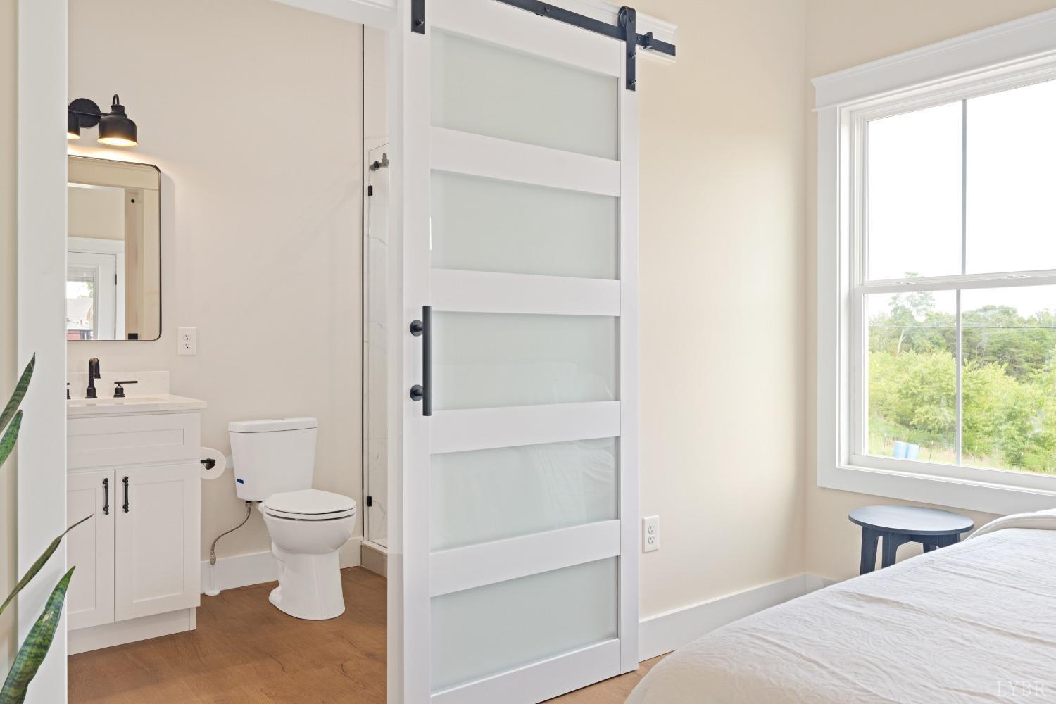 6605 Forest Road Goode, VA 24556 - Photo 40 of 58 a bathroom with a toilet sink and a mirror