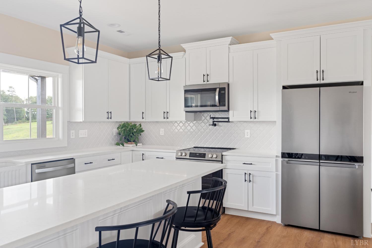 6605 Forest Road Goode, VA 24556 - Photo 47 of 58 a kitchen with stainless steel appliances a stove a sink refrigerator and microwave