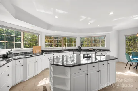 a kitchen with granite countertop a sink and a stove