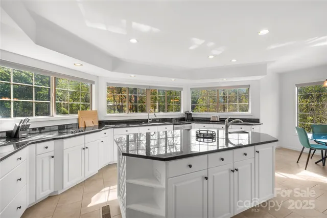a kitchen with granite countertop a sink and a stove