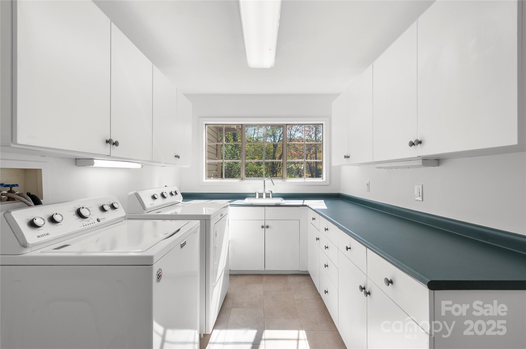 108 June Court Lake Lure, NC 28746 - Photo 14 of 46 a kitchen that has a sink and a stove in it