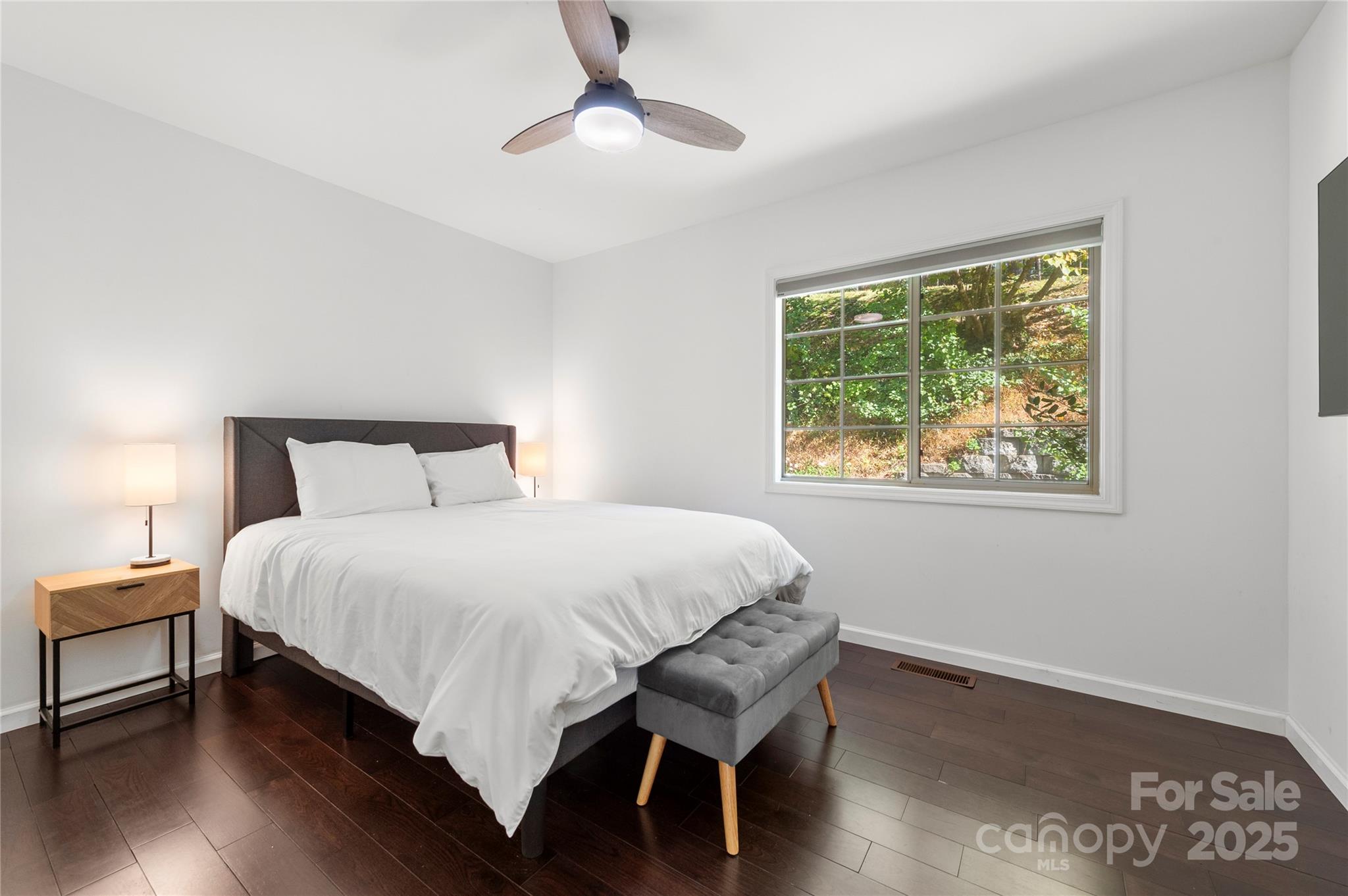 108 June Court Lake Lure, NC 28746 - Photo 15 of 46 a bedroom with a bed and wooden floor