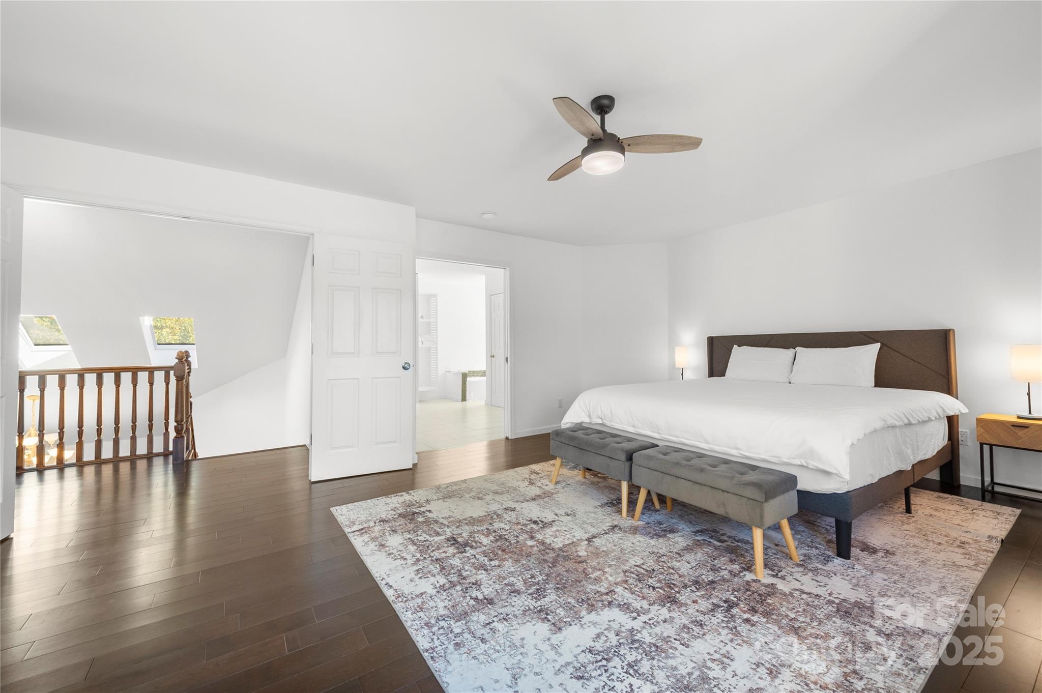 108 June Court Lake Lure, NC 28746 - Photo 20 of 46 a spacious bedroom with a bed and wooden floor