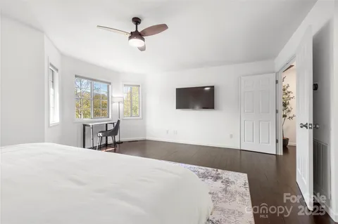 a spacious bathroom with a granite countertop sink a shower and a mirror