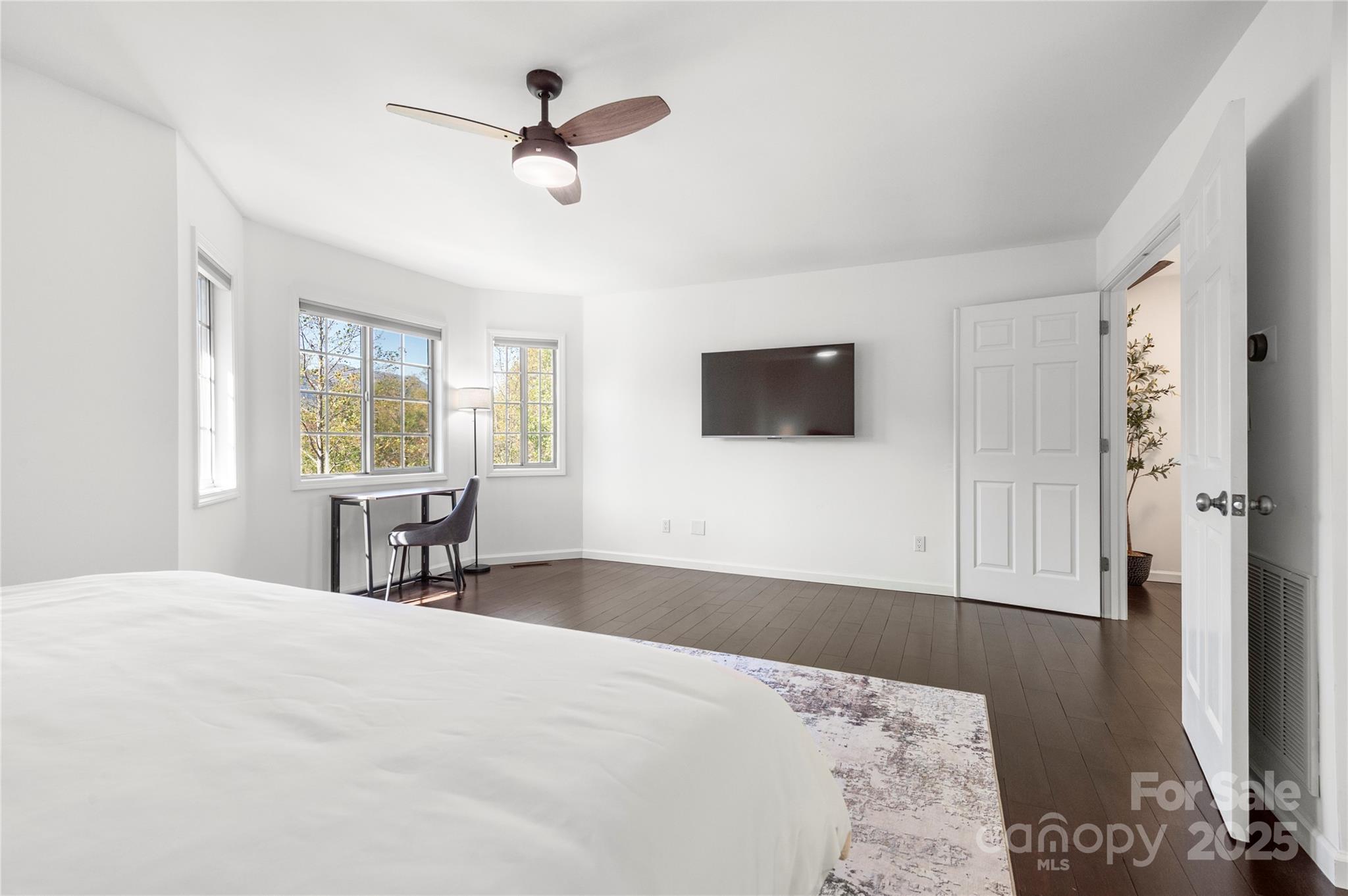 108 June Court Lake Lure, NC 28746 - Photo 21 of 46 a bedroom with a bed a window and a flat screen television