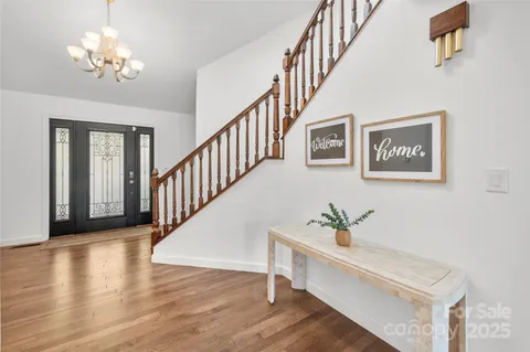 a view of staircase with lots of frames and wooden floor