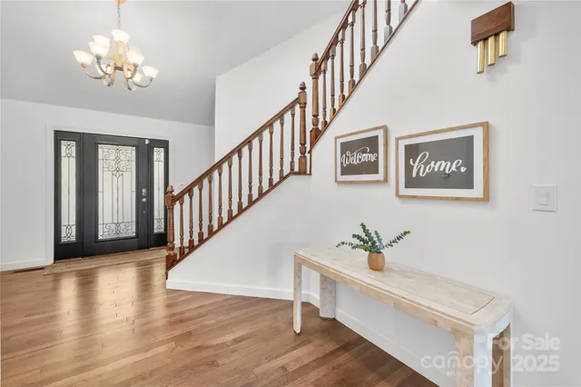 a view of staircase with lots of frames and wooden floor