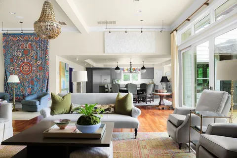 a living room with furniture and a chandelier