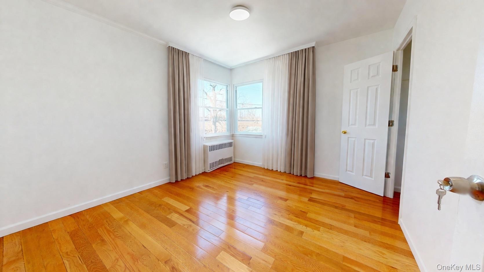 219-42 141st Road Queens, NY 11413 - Photo 21 of 23 a bedroom with a bed and a window