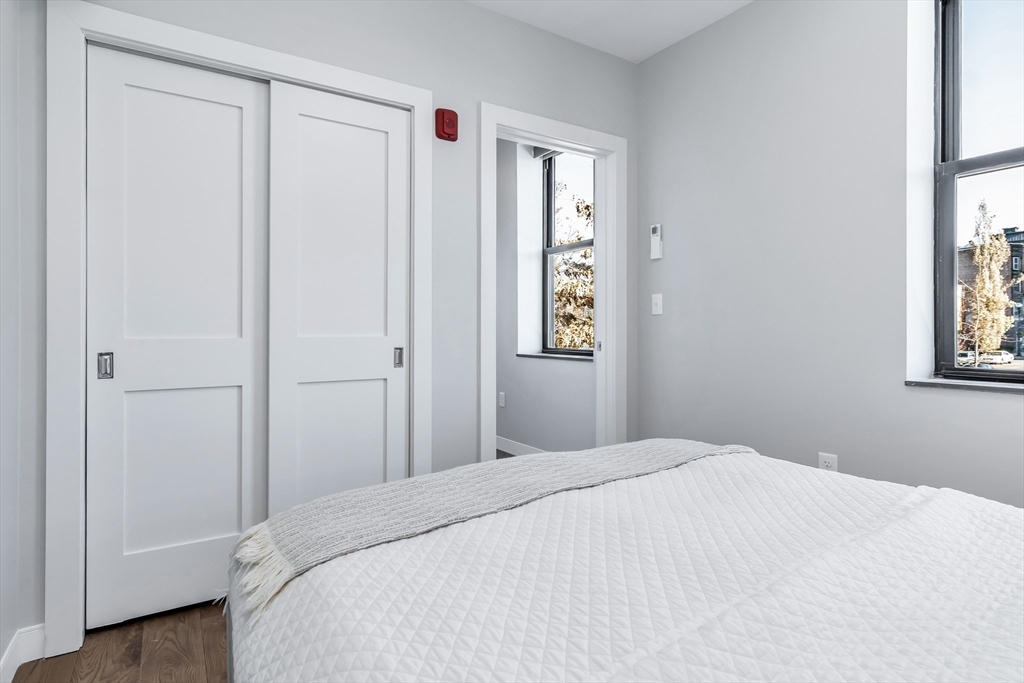 200 Merrimack Street, Unit 201 Haverhill, MA 01830 - Photo 13 of 17 a bedroom with a bed and a window