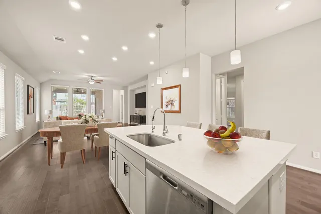 a kitchen with sink and wooden floor