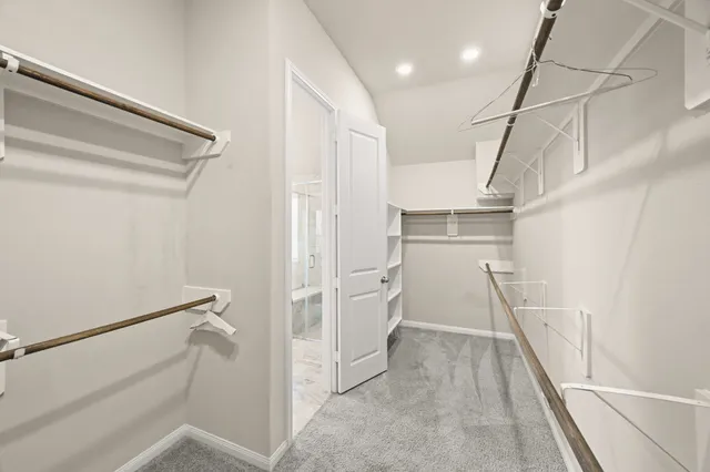 a white bath tub sitting in a bathroom next to a window