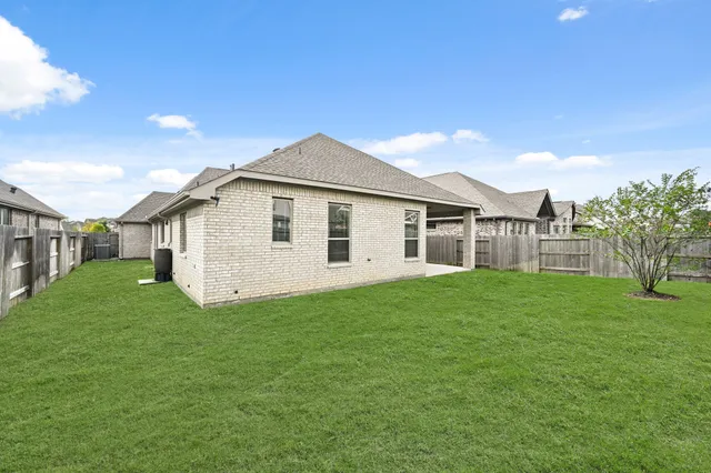 a view of a house with a yard and sitting area