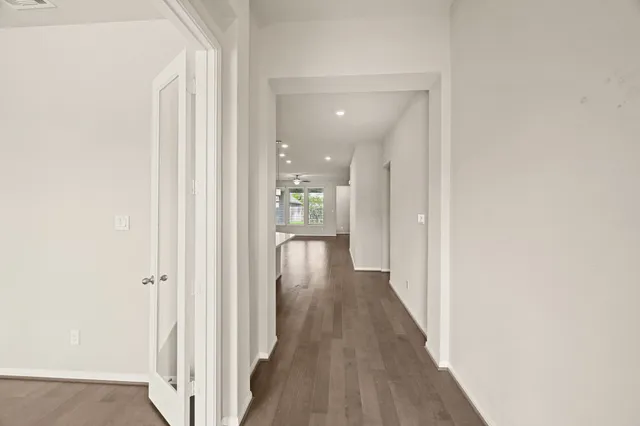 a view of a hallway with wooden floor