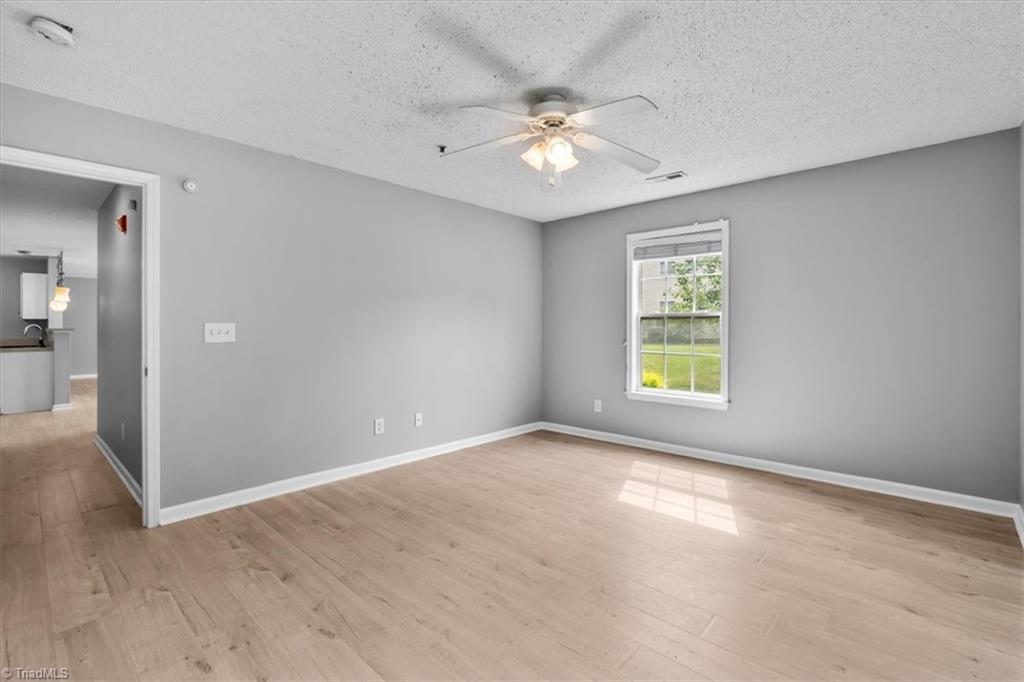 133 James Road, Unit IC High Point, NC 27265 - Photo 10 of 17 Primary bedroom suite with walk-in closet and adjoining bath with shower and updated vanity