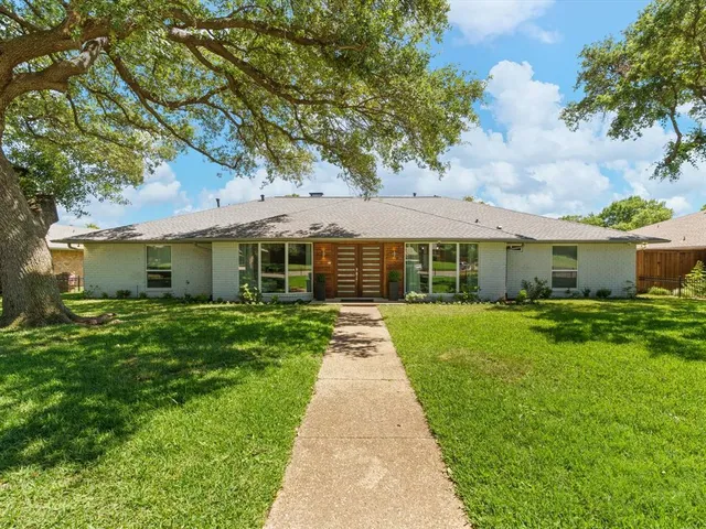 a front view of a house with a yard and porch