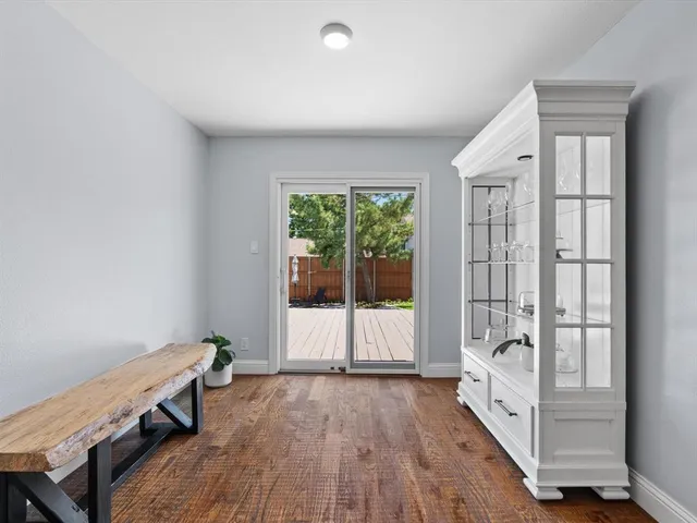 an entryway with wooden floor and windows