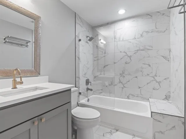 a bathroom with a sink a toilet and a bathtub