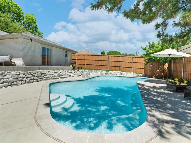 a view of a backyard with sitting area