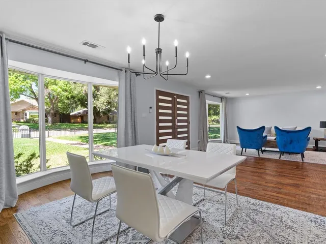 a view of a dining room with furniture wooden floor and a chandelier