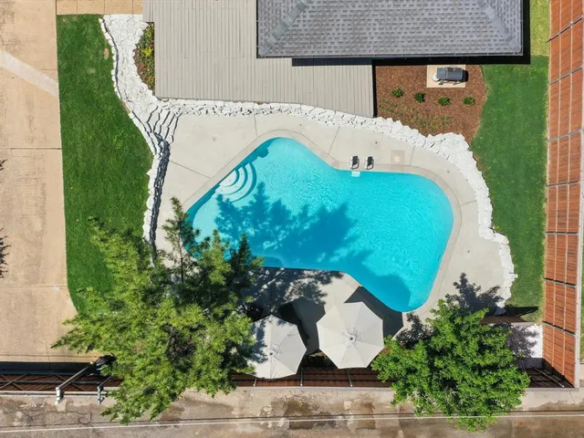 an aerial view of a house with garden space and street view