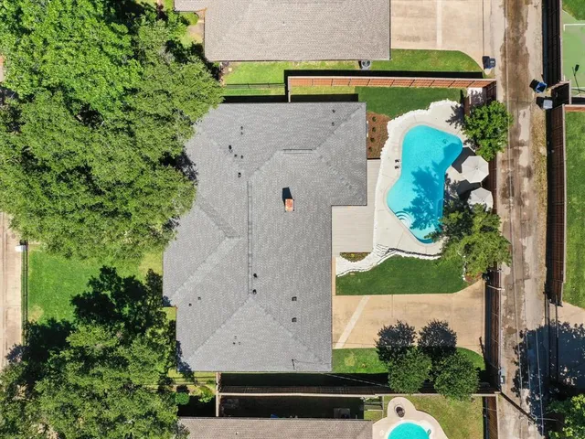 an aerial view of a house with a swimming pool