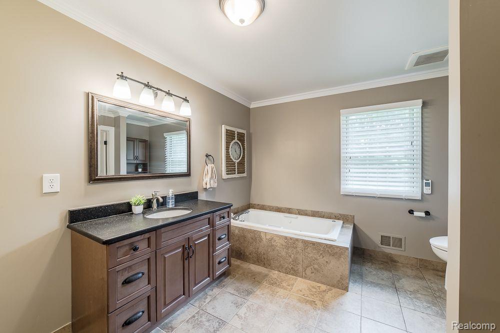 8360 Woodview Road Clarkston, MI 48348 - Photo 37 of 61 Jetted tub and 2 vanity areas