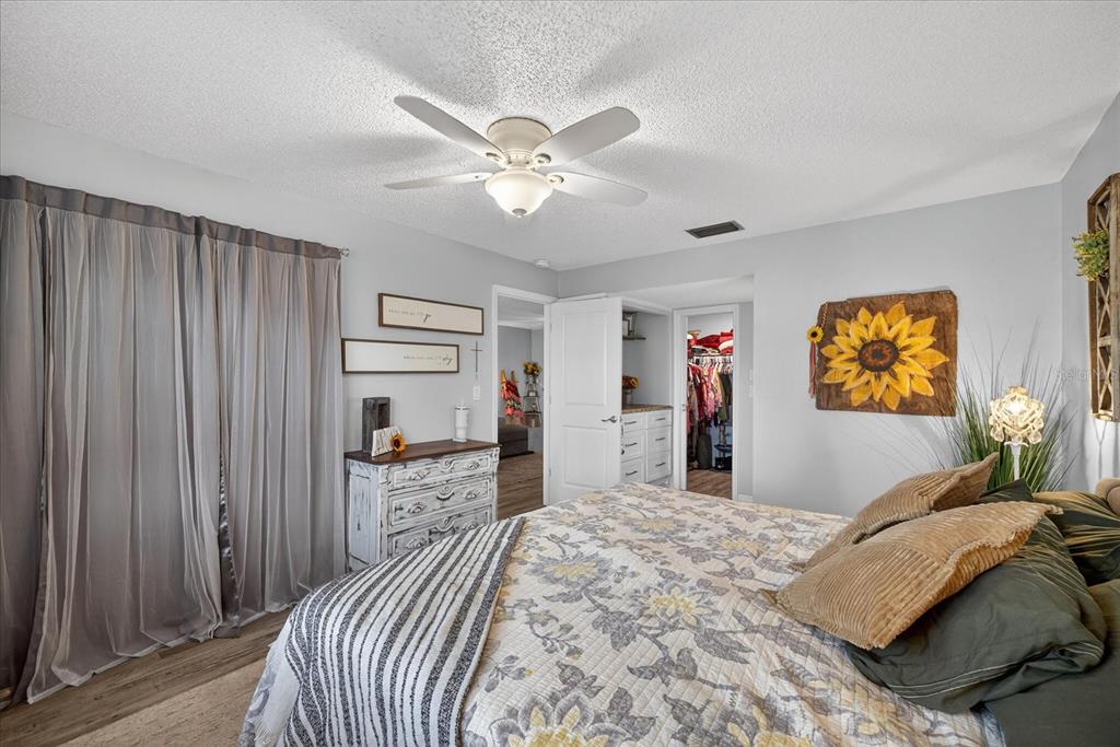 3230 Teeside Drive New Port Richey, FL 34655 - Photo 13 of 32 a bedroom with a bed and a chandelier