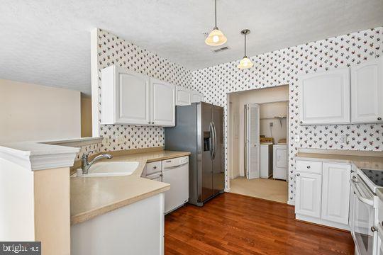 9511 Kingscroft Terrace, Unit 9511F Perry Hall, MD 21128 - Photo 21 of 38 a kitchen that has a sink a refrigerator and cabinets