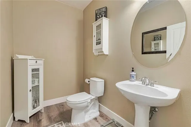 a view of a storage and utility room with wooden floor