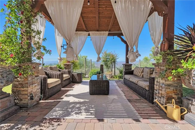 a view of a patio with couches and potted plants